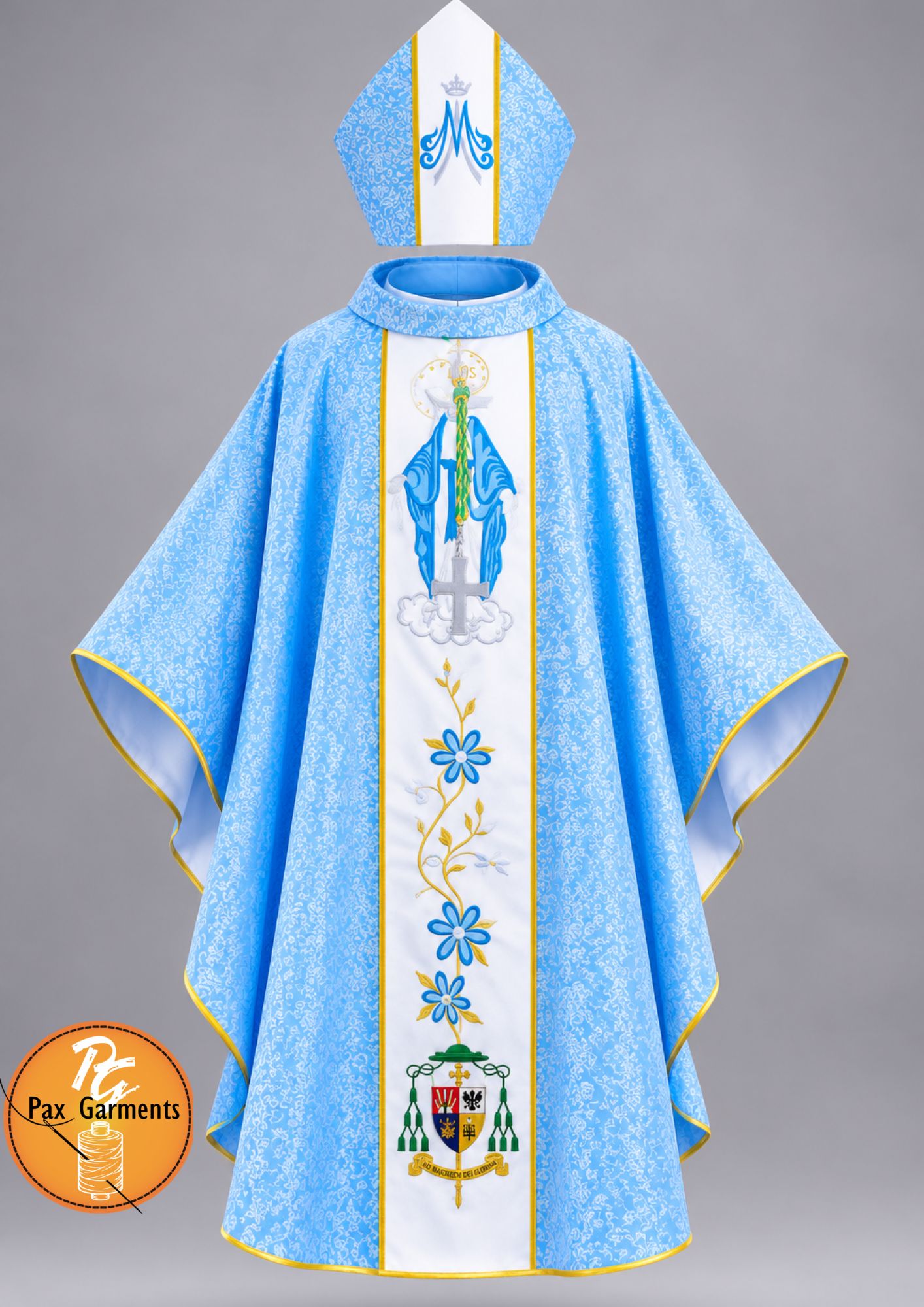 Light blue Marian Gothic chasuble set with matching mitre, crafted from patterned brocade fabric with a central white orphrey band featuring Marian iconography and floral embroidery.